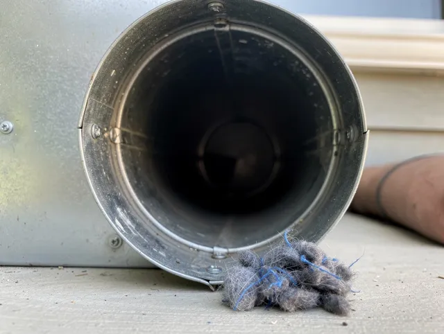 Hilliard Dryer Vent Cleaning technician using specialized equipment to clear severe dryer vent blockage in Hilliard